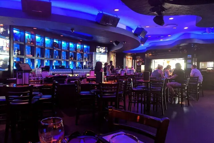 People enjoying drinks at bar of Blue Martini Lounge Naples