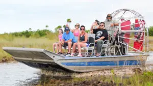 A group of vacationers enjoying Wooten's Everglades Airboat Rides. A fan boat tour, through the everglades.