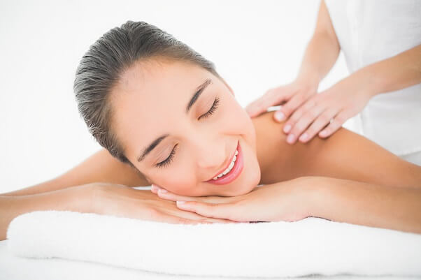 Attractive woman receiving back massage in spa center