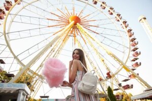 Happy young lady standing ferris wheel