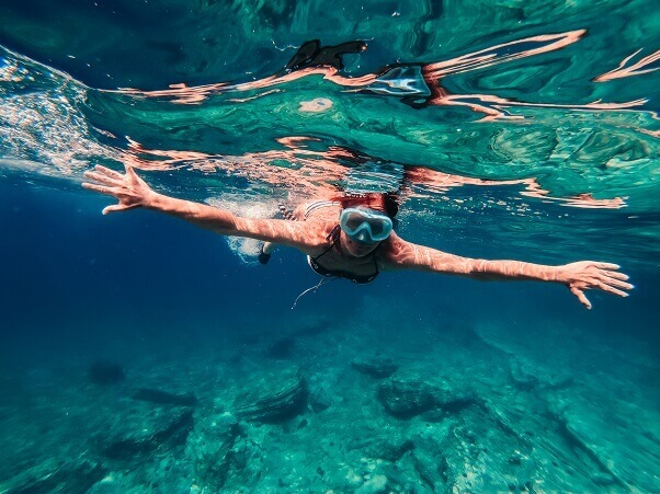 Woman snorkeling in shallow sea water