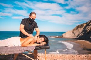 Massage at beach coast near sea masseuse