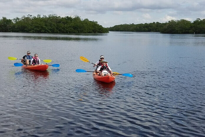2 Couples enjoying kayaking at long term RV resort