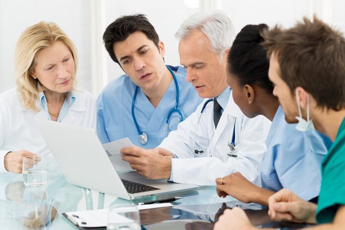 Team Of Expert Doctors Examining Medical Reports 