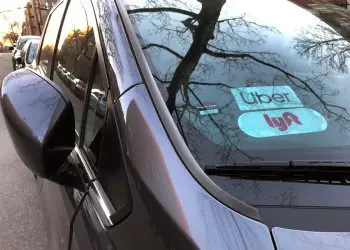 Uber and Lyft sign in windshield of car, Queens, New York. (Photo by: Lindsey Nicholson/Education Images/Universal Images Group via Getty Images)